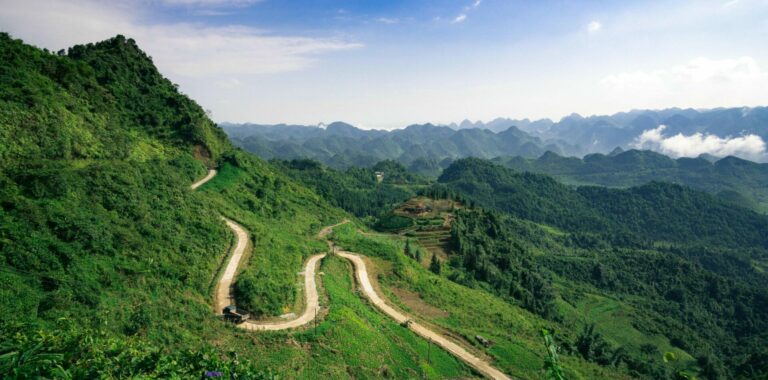 Windy road through lush green mountains in Northern Vietnam