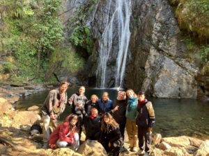 group of people in front of waterfall