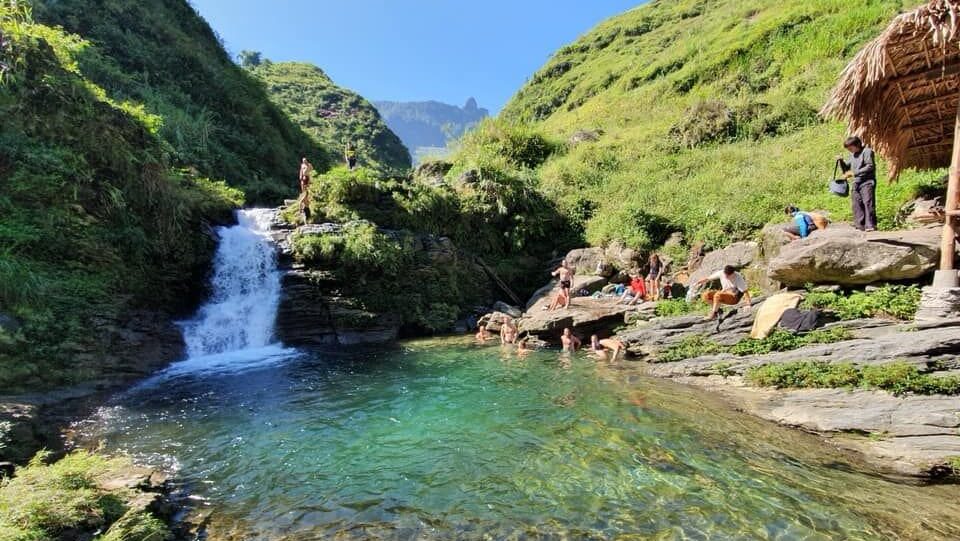 Sunny day at a waterfall with blue water