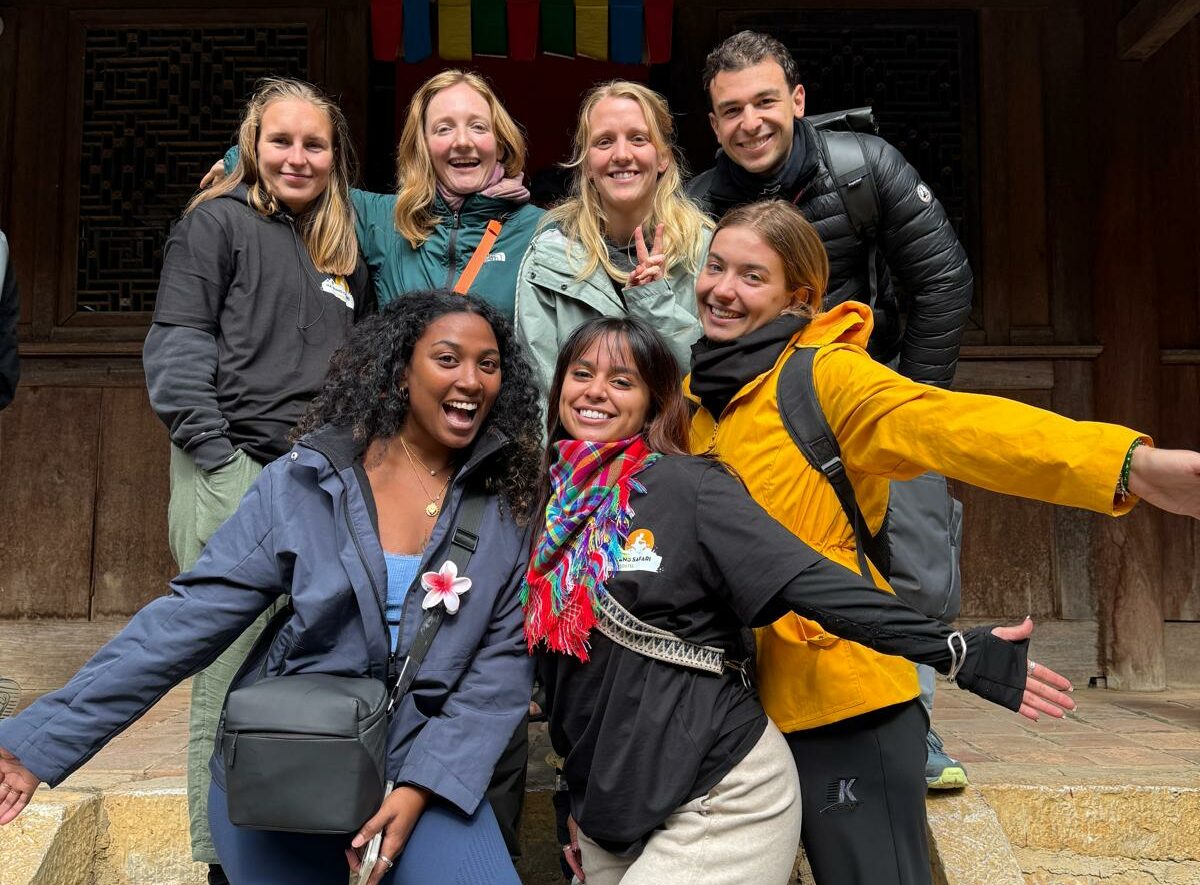 Group of happy travelers outside the H’Mong King Palace