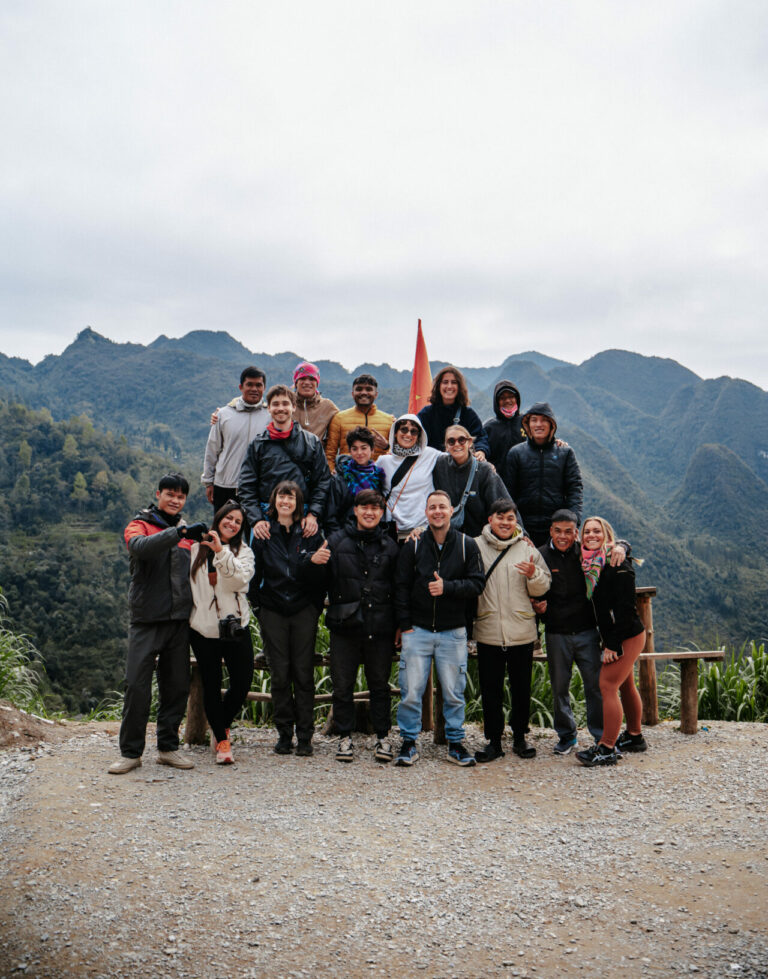 Group of travelers in front of mountains on the Ha Giang Loop