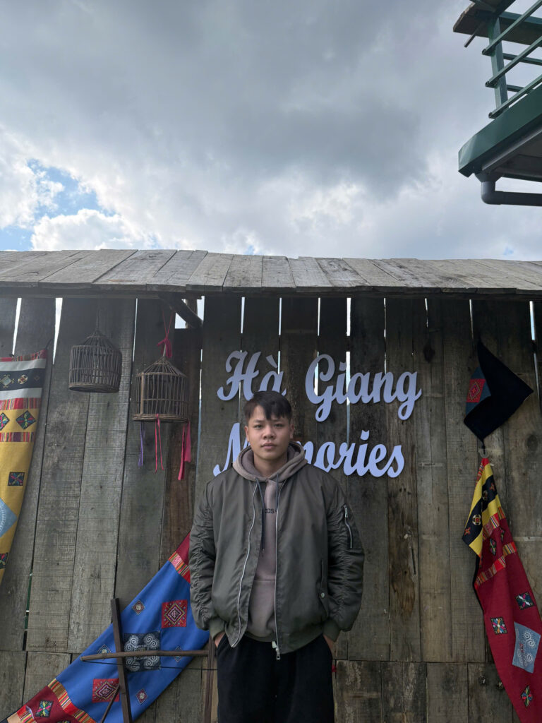 Easy rider in front of sign on the Ha Giang Loop