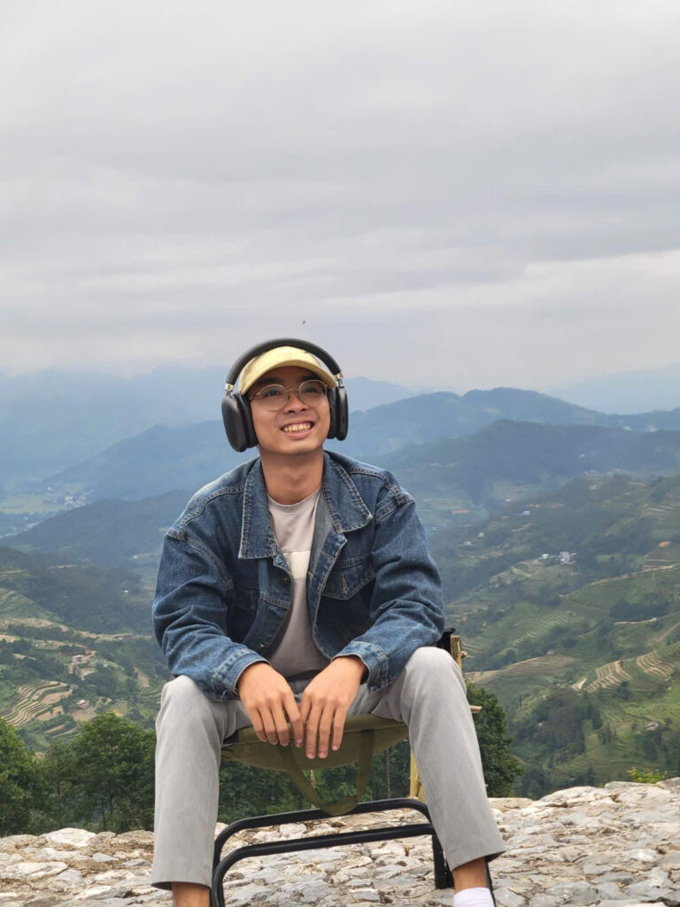 Boy in nature with headphones smiling