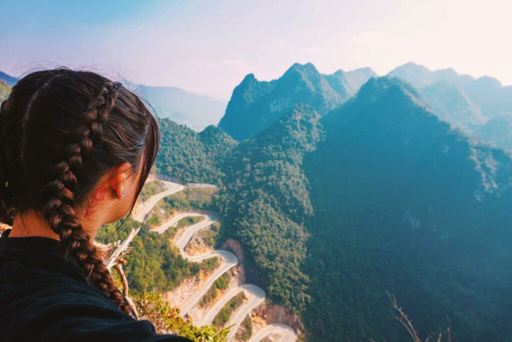 road with 14 passes and a girl looking at the mountains