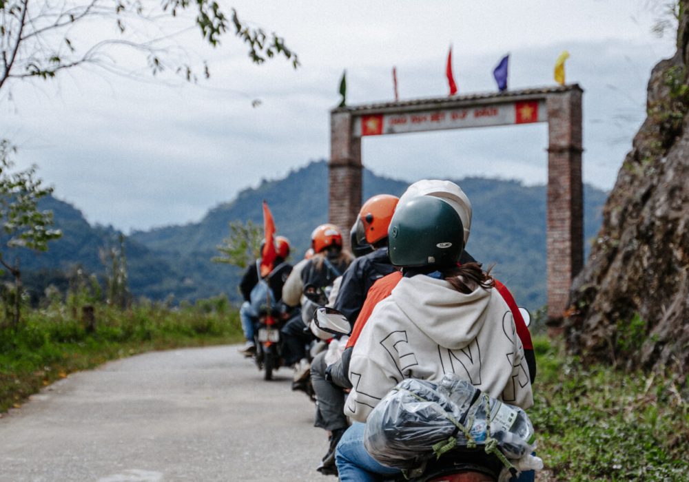 Motorcycle tour group driving through the mountains on a road