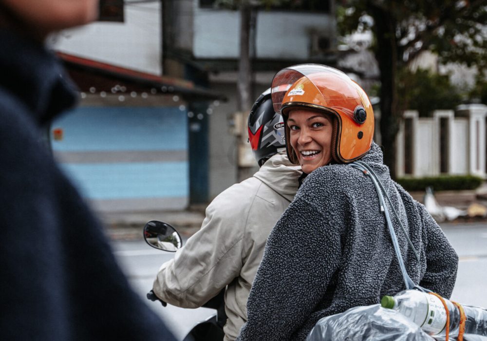 Happy girl on the back of a scooter